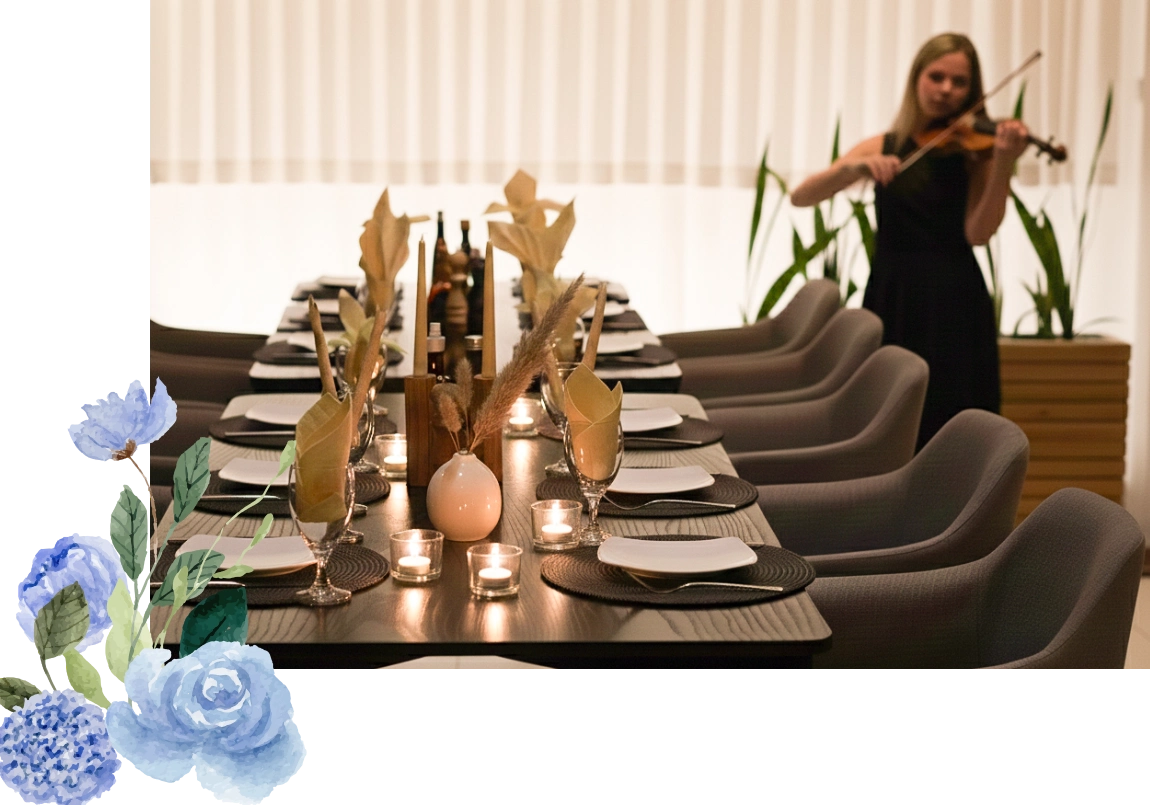 Elegant dining table set with floral centerpieces and candles, ready for a formal event.