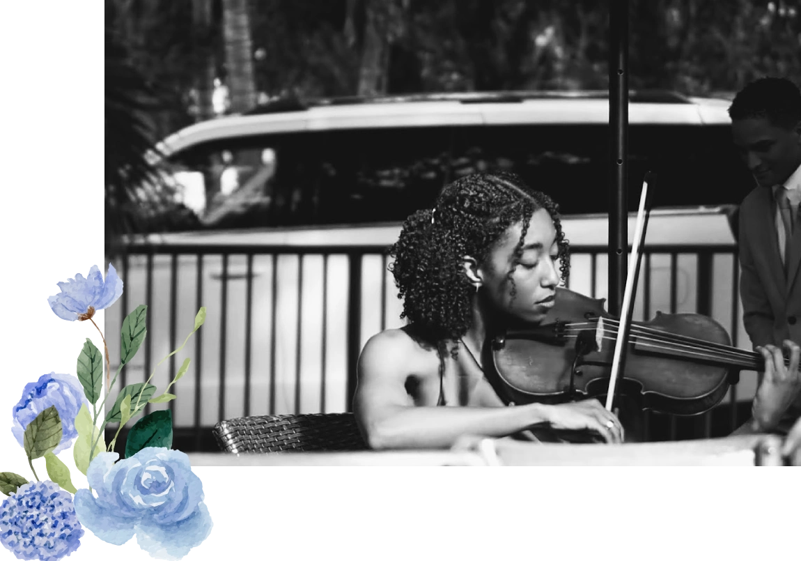 Woman playing violin with focused expression outdoors.